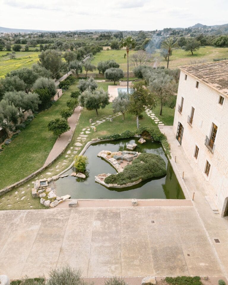 Aerial view of the lush gardens and pond at Finca Morneta, showcasing serene landscaping and countryside surroundings, captured by Puy Cermeno.