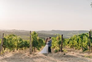 The newlyweds share a quiet moment walking through the lush vineyards of Quercia al Poggio.