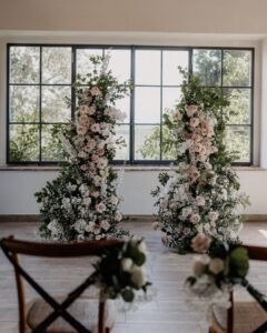 A romantic flower arch set for an intimate Tuscan wedding ceremony at Quercia al Poggio.