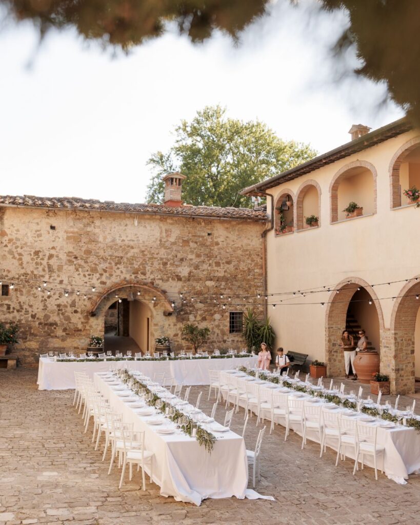 The textured stone walls of Quercia al Poggio glow under the Tuscan sun, exuding historic charm.
