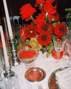 A romantic outdoor reception table with delicate place settings and soft lighting.