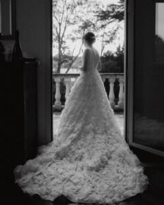The bride poses in an arched doorway at Villa Donna Camilla, framed by historic stone walls.