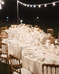 Elegant floral centerpieces adorn the candlelit reception tables at Villa Donna Camilla.