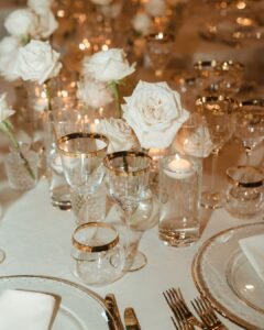 Elegant white roses arranged in delicate vases as centerpieces for a reception at Villa Donna Camilla.
