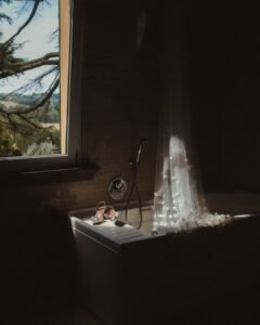 A delicate bridal veil and designer shoes elegantly placed in a vintage bath at Villa Donna Camilla.