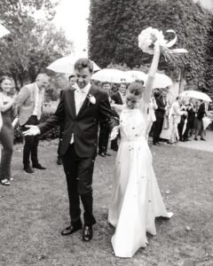 Couple smiling as guests throw confetti at their Château Rigaud wedding.