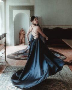 Bride twirling in her flowing black gown with trailing veil in a sunlit room at Villa Ivana.