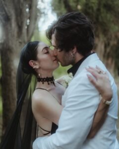 Intimate close-up of bride and groom sharing a romantic kiss beneath the trees at Villa Ivana.