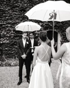 Groom listening to vows during outdoor ceremony at Château Rigaud.