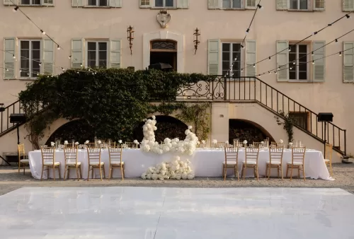 Al fresco wedding reception at Bastide du Roy, with tables set beneath twinkling string lights.