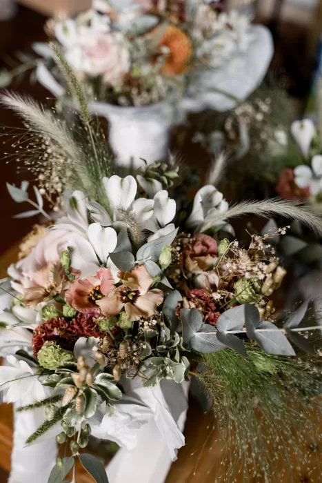 Romantic bridal bouquet with soft pinks, greens, and dried textures at Borgo Sant Ambrogio.