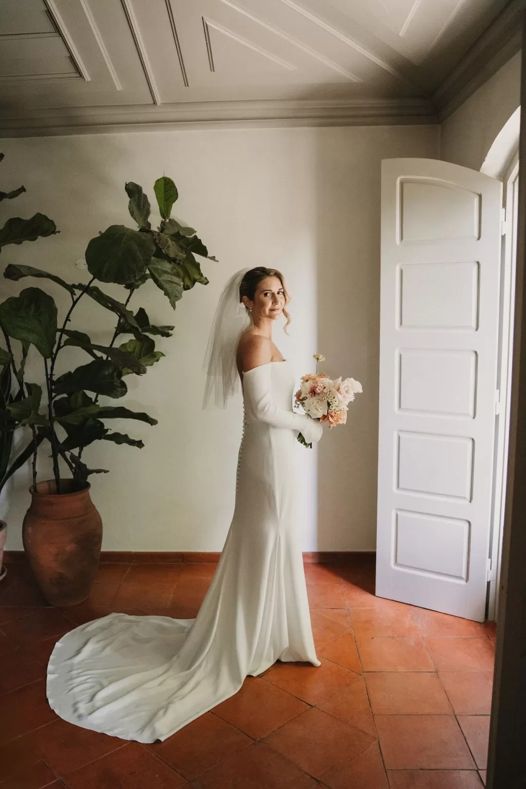 Bridal portrait in a rustic doorway at Casa Sacoto, blending old-world charm and elegance.