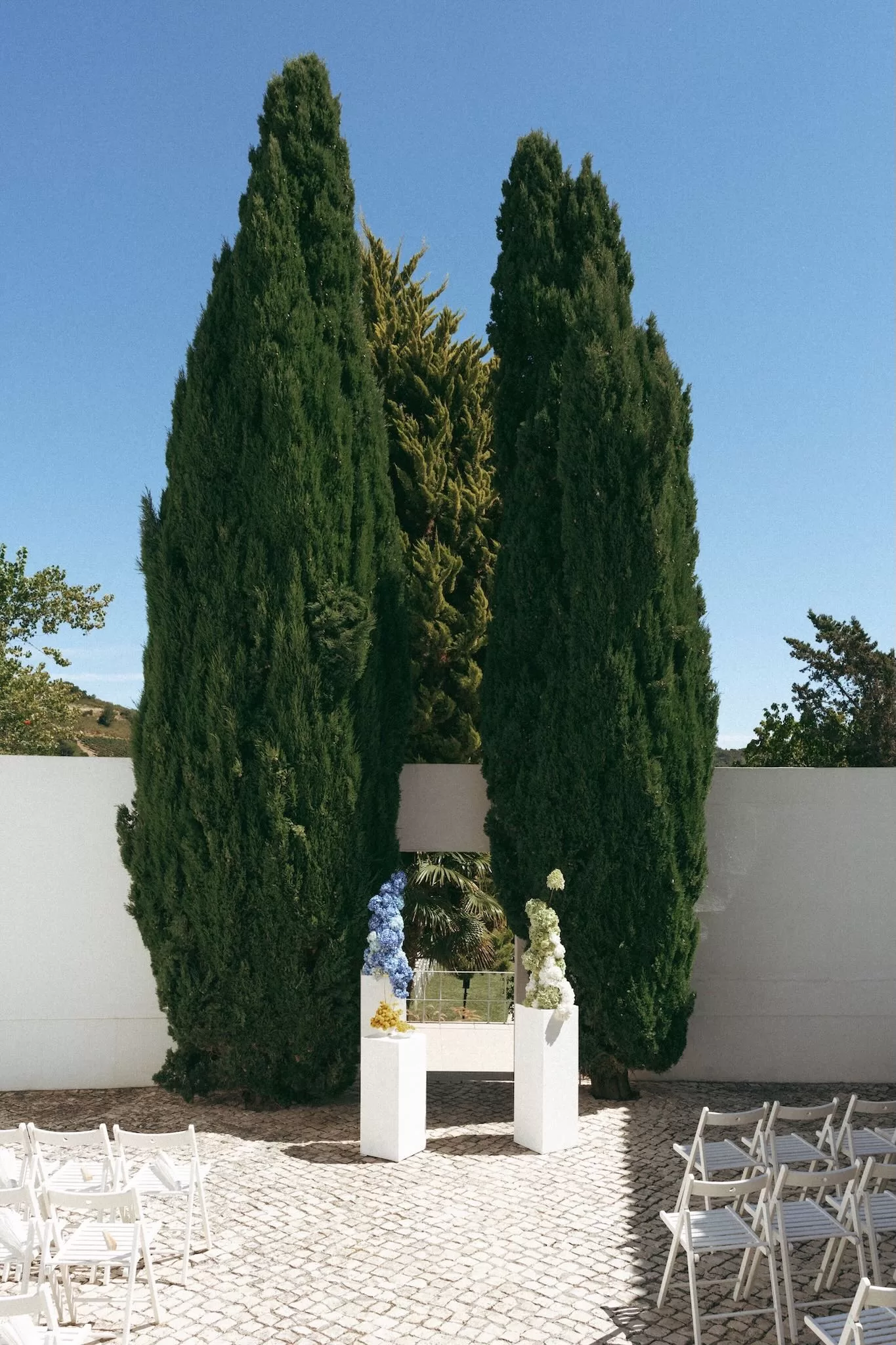 Ceremony setup at Casa Sacoto featuring minimalist seating and views of the surrounding greenery.