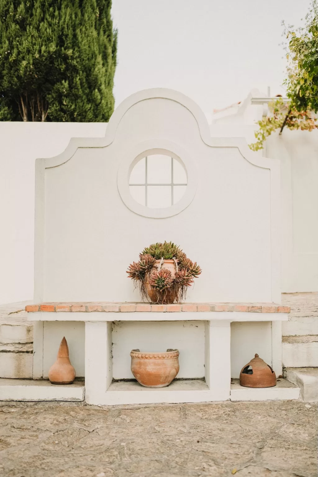 Display installation on a whitewashed wall at Casa Sacoto with Mediterranean style.