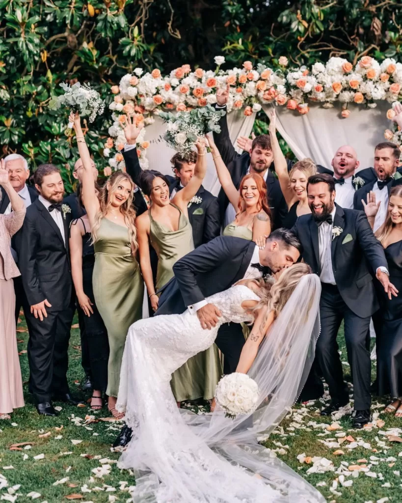 Emotional wedding ceremony under an arch of florals in the grounds of Villa Ravano