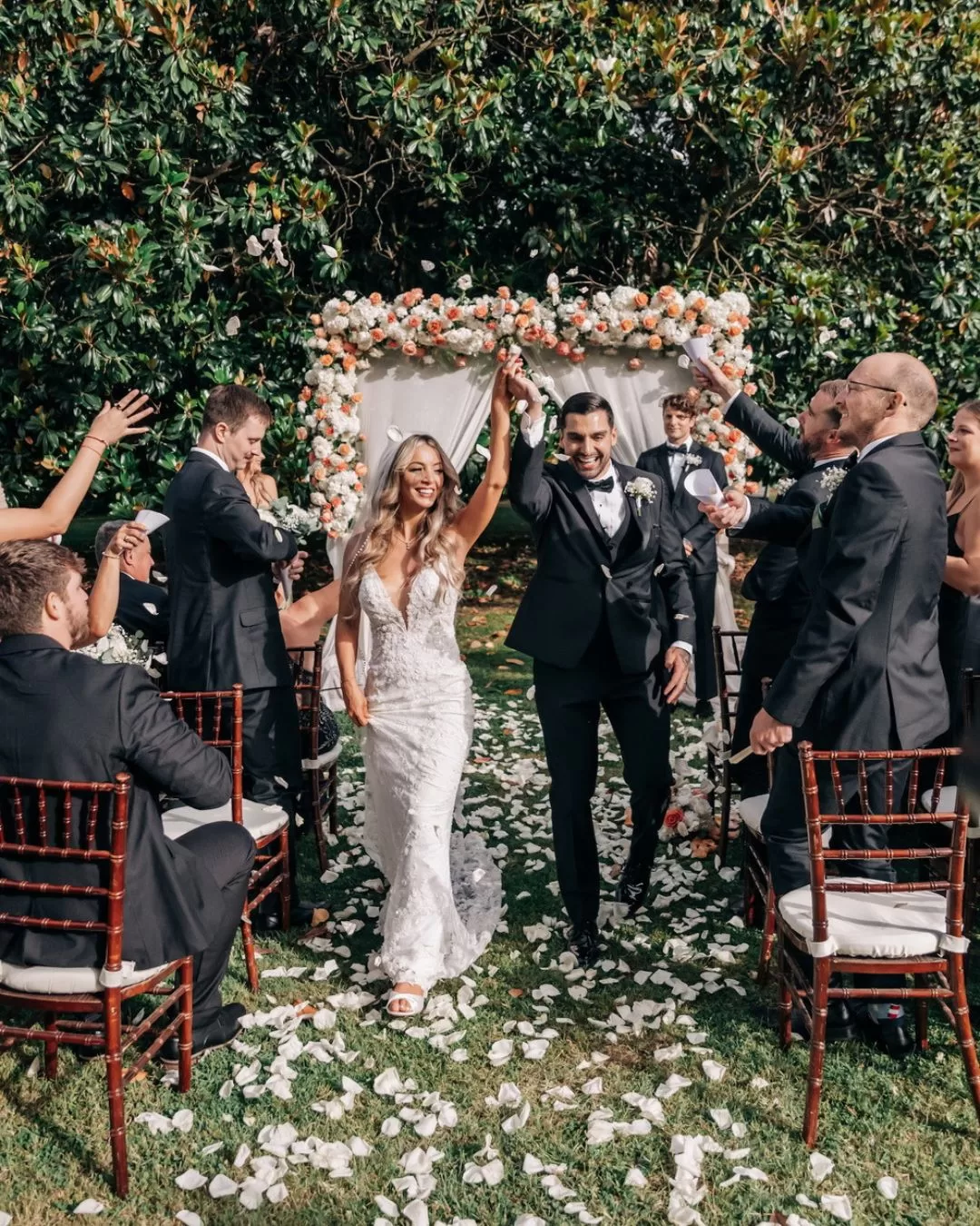 Outdoor wedding ceremony at Villa Ravano with the couple exchanging vows surrounded by greenery