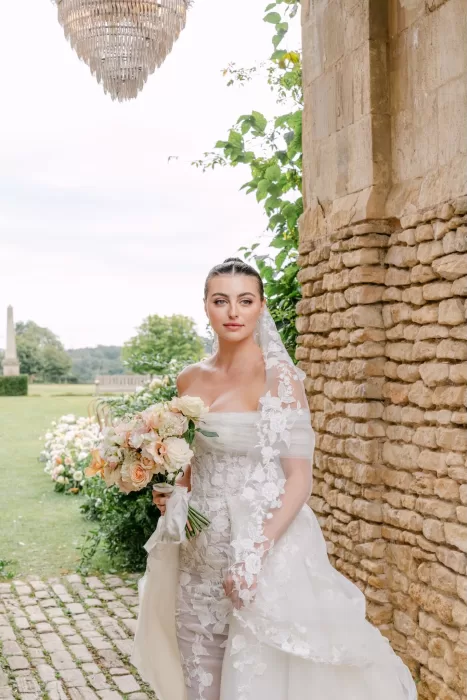 Bridal portrait at Euridge Manor, with soft window light highlighting the gown’s floral embroidery and long veil.