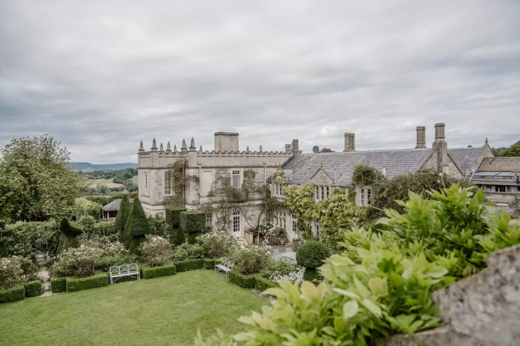 Elevated view of Euridge Manor’s historic facade and manicured garden, set against the rolling countryside.