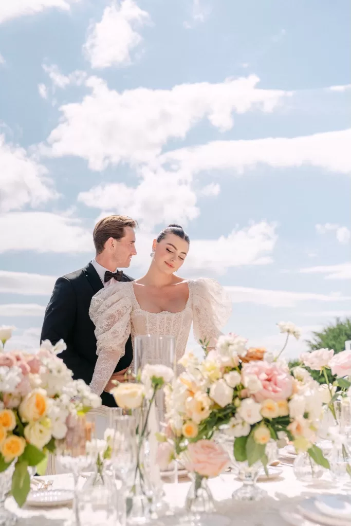 Romantic portrait of the couple at Euridge Manor with lush flowers and dreamy summer skies.
