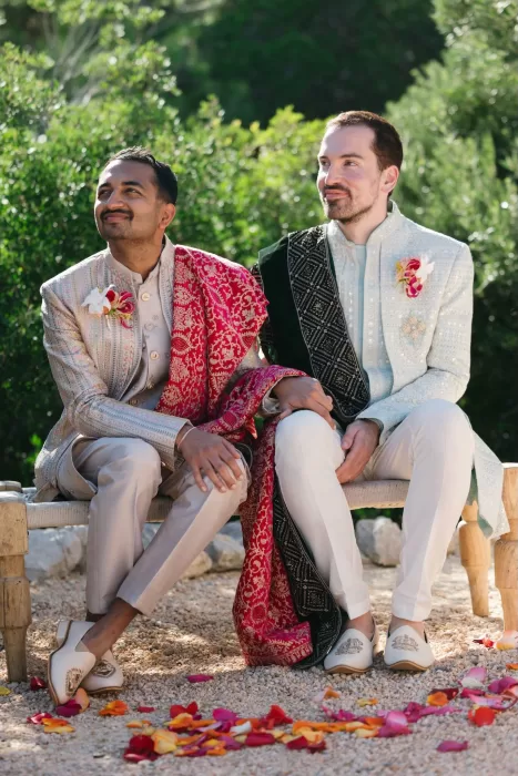 Grooms wearing traditional Indian attire during their ceremony at Masia Casa del Mar.
