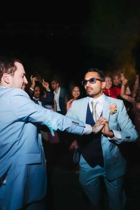 Grooms dancing under the stars during their wedding celebration at Masia Casa del Mar.