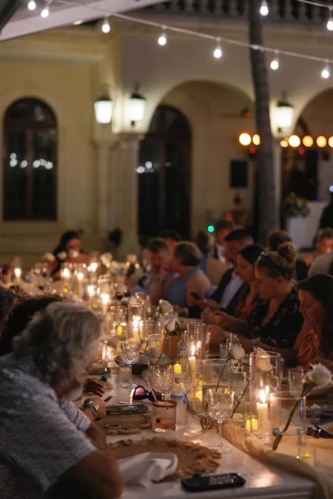 Warm candlelight and rose decor setting the mood for a romantic outdoor dinner at Villa La Joya.