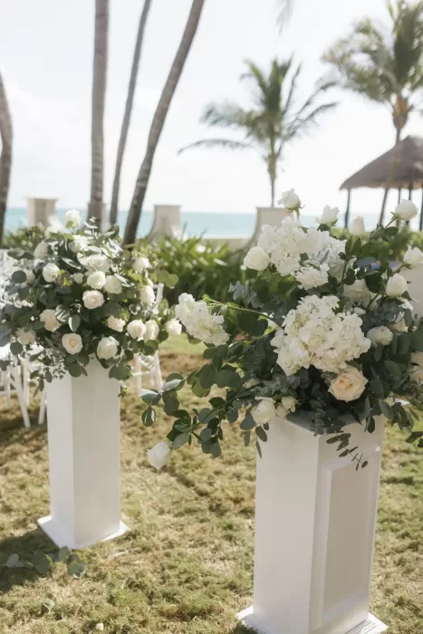 White floral ceremony arrangement with greenery at the grand entrance of Villa La Joya.