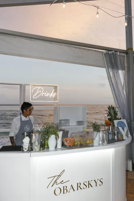Modern wedding cocktail bar setup at Villa La Joya with ocean views and sunset lighting.