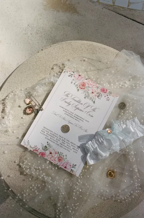 Wedding invitation and bridal accessories styled with pearls and florals at Villa La Joya.