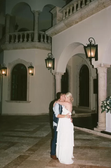 Bride and groom share a quiet nighttime dance in the stone courtyard of Villa La Joya
