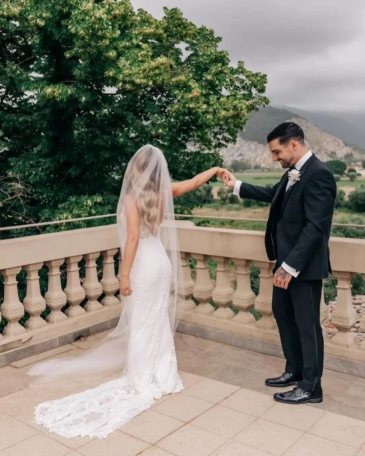 Bride in flowing veil standing in the gardens of Villa Ravano, bathed in soft natural light