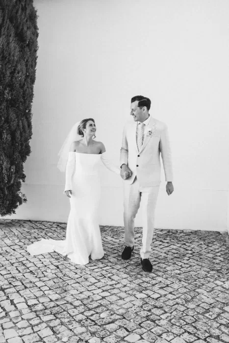 Bride and groom walking hand in hand through the gardens at Casa Sacoto