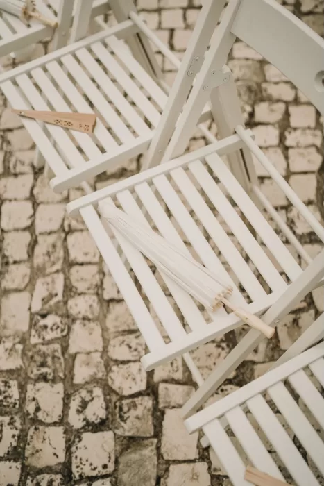 Guest chair detail with program and fan at Casa Sacoto