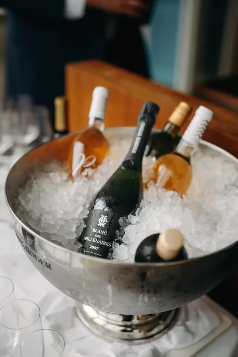 Elegant champagne and wine bottles on ice, ready for celebration at a wedding reception in Hotel Villa Honegg.