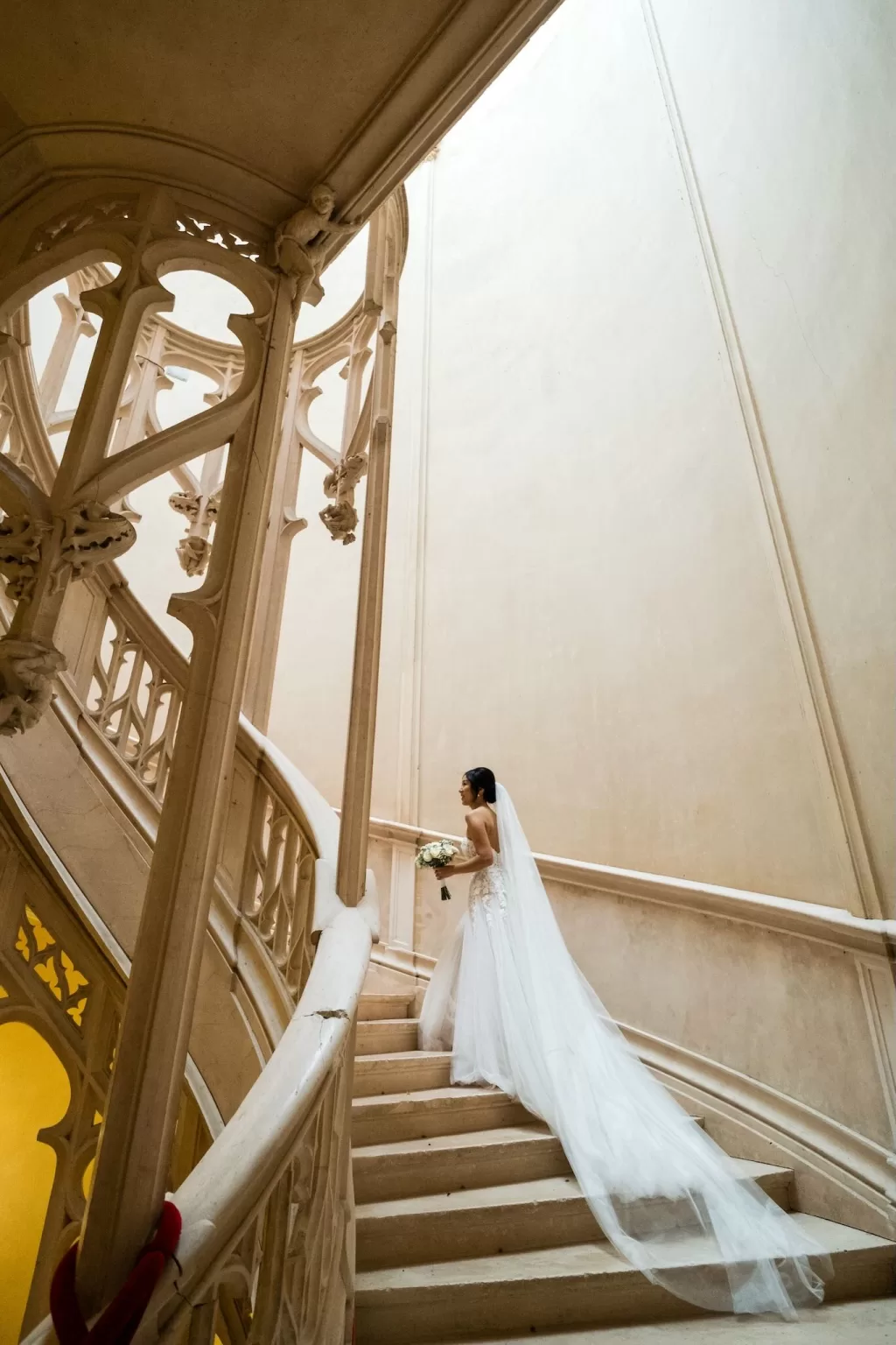 Black and white portrait of the bride framed in Château Challain’s grand arched doorway.