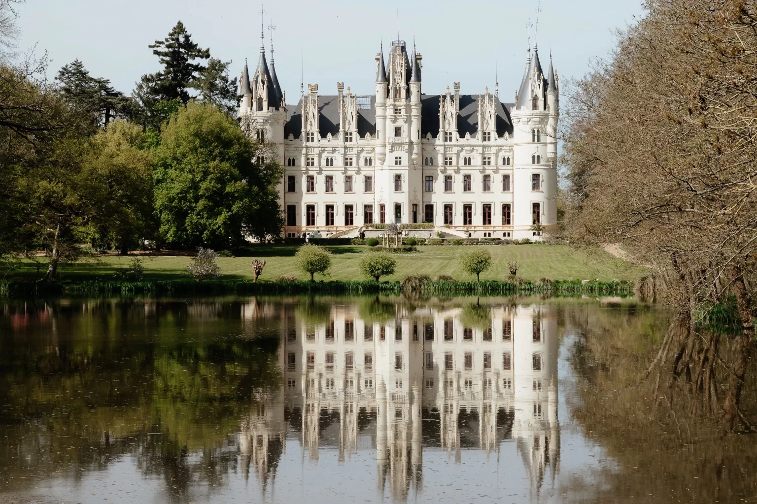 Chateau Challain reflected beautifully in the calm waters of the surrounding lake.