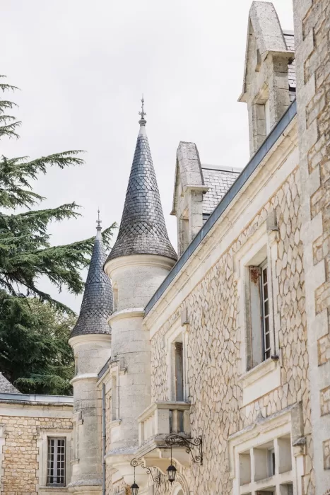 Close-up of fairytale turrets rising above the stone façade at Château de la Couronne.