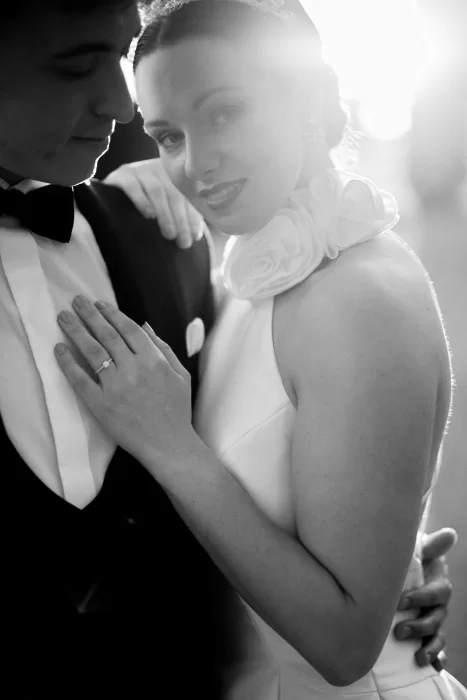 Romantic close-up of bride and groom, soft sunlight streaming behind them at Château de Sanse.