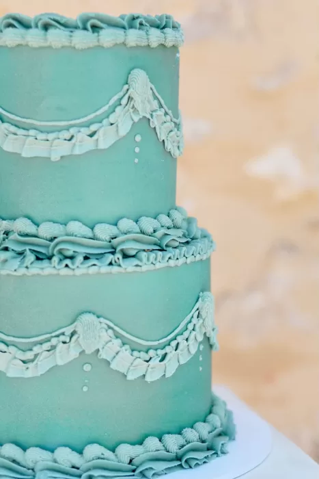 Intricate vintage-style green wedding cake at Chateau de Sanse with delicate piped detailing.