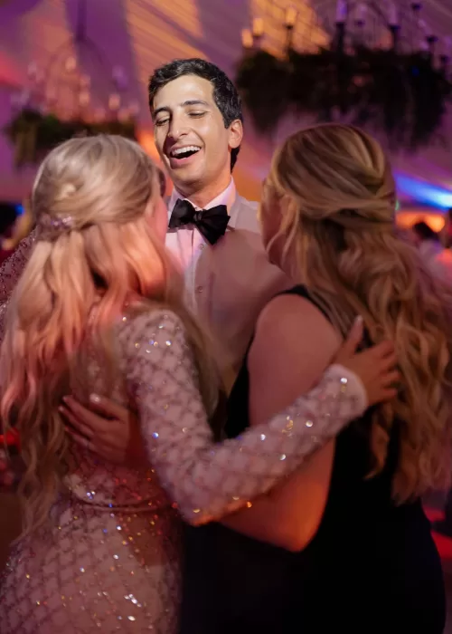 Groom laughs joyfully with guests on the dancefloor during the reception at Cigarral de las Mercedes.