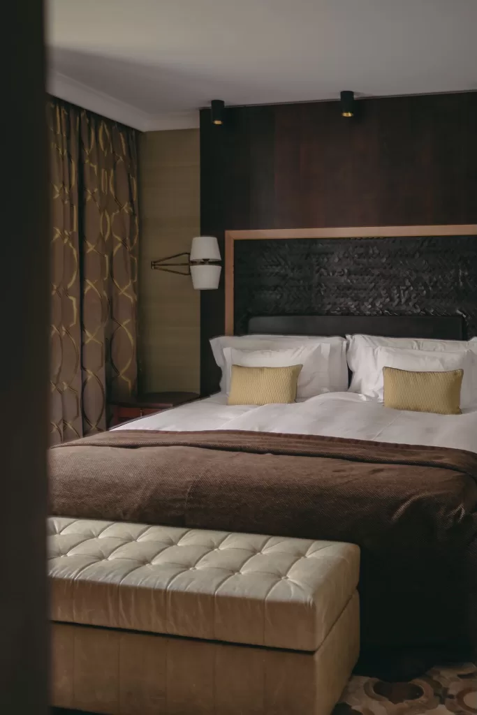 Elegant bedroom with warm tones and plush textures at Hotel Villa Honegg.