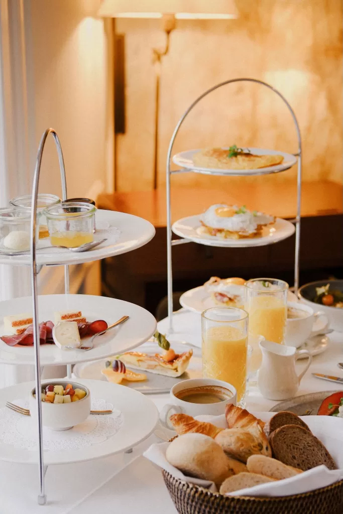 Gourmet breakfast served in-room at Hotel Villa Honegg with fresh juice, coffee, and pastries.