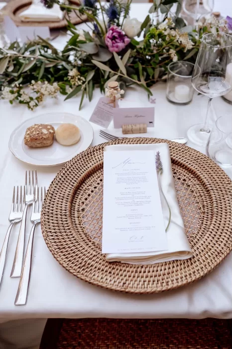 Woven charger plate with printed menu and lavender sprig at Borgo Sant'Ambrogio wedding reception.