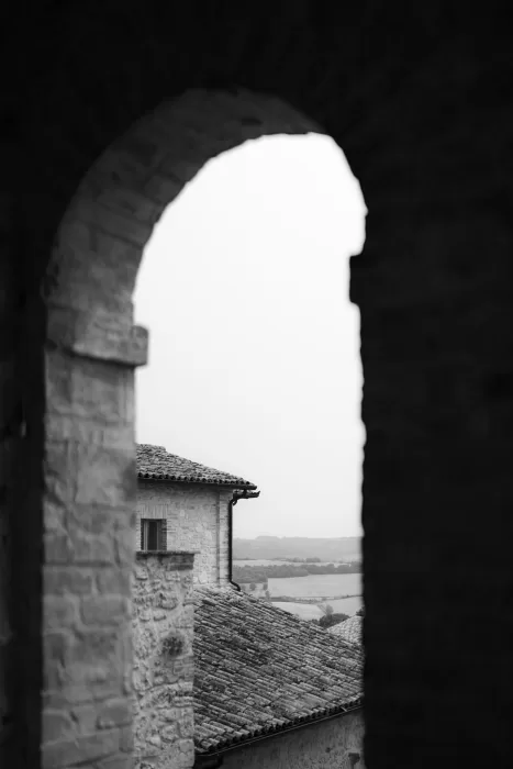 View through an ancient archway at Castello di Montignano overlooking the Umbrian countryside