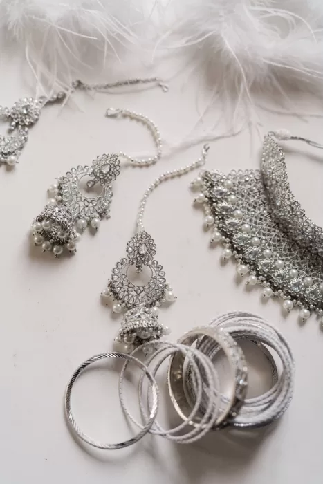 Delicate bridal jewellery with pearls and silver set out before the wedding at Castello di Montignano.
