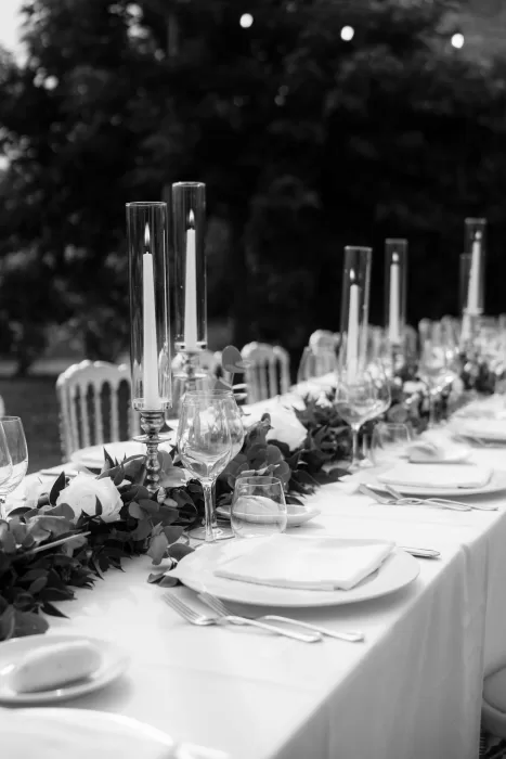 Close-up of romantic candlelit tablescape with florals and glassware at Castello di Montignano