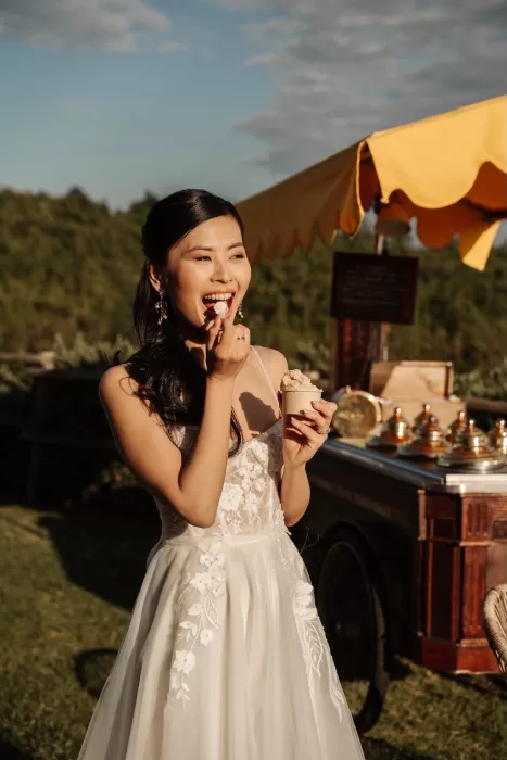 Bride enjoying gelato from vintage cart in the afternoon sun at Conti di San Bonifacio.