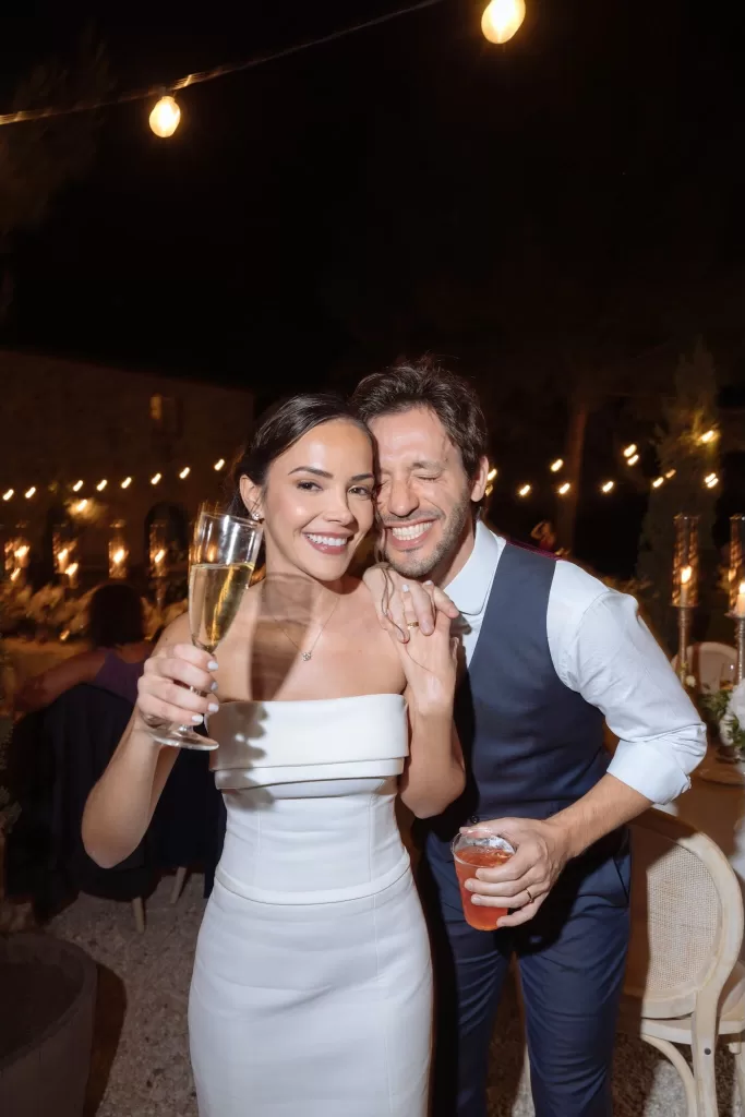 Bride and groom laughing and toasting during the evening celebrations at Conti di San Bonifacio.