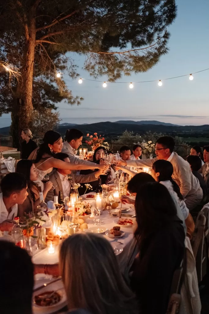 Intimate al fresco dinner with candlelight and views of rolling Tuscan hills at Conti di San Bonifacio.