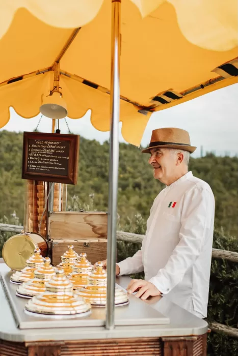 Traditional Italian gelato cart with cheerful vendor at Conti di San Bonifacio wedding celebration.